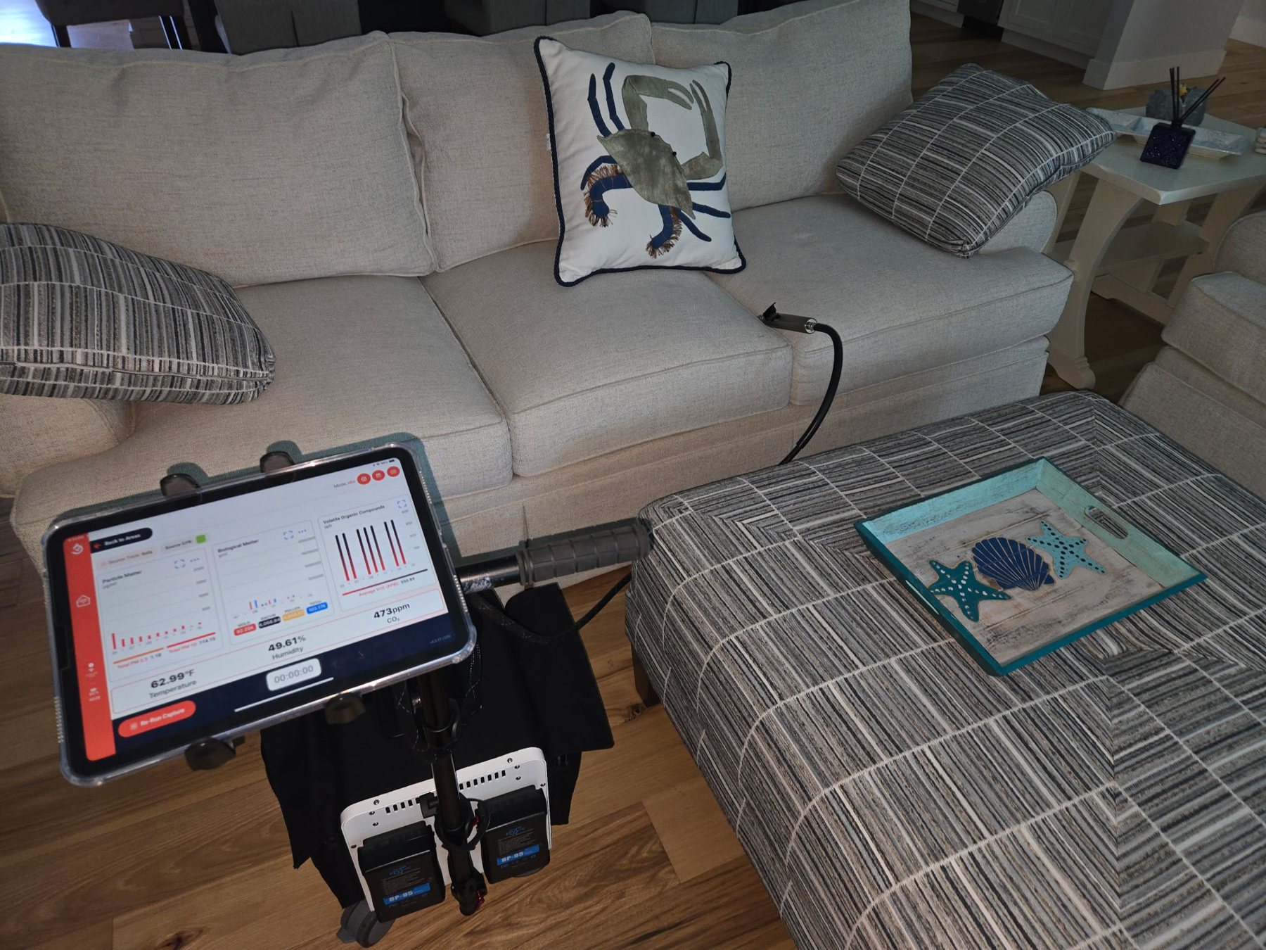 InstaScope air monitor taking readings in a furnished living room